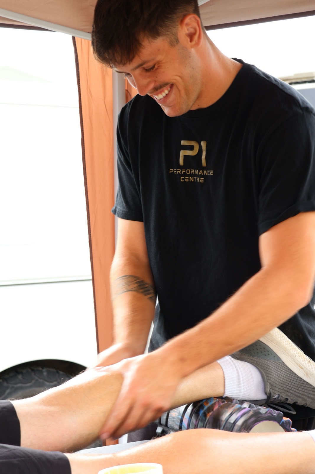 Iestyn treating a client's leg during a sports therapy session